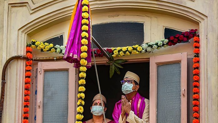 Residents dressed in traditional attire celebrate Gudi Padwa during a nationwide lockdown in the wake of coronavirus pandemic, at Girgaon in Mumbai, on 25 March 2020