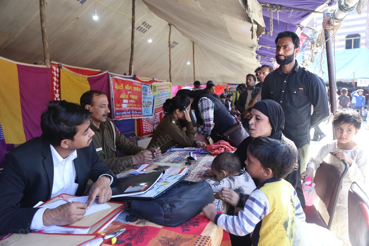 The legal and police help desks at the Mustafabad relief camp helping people file complaints. 