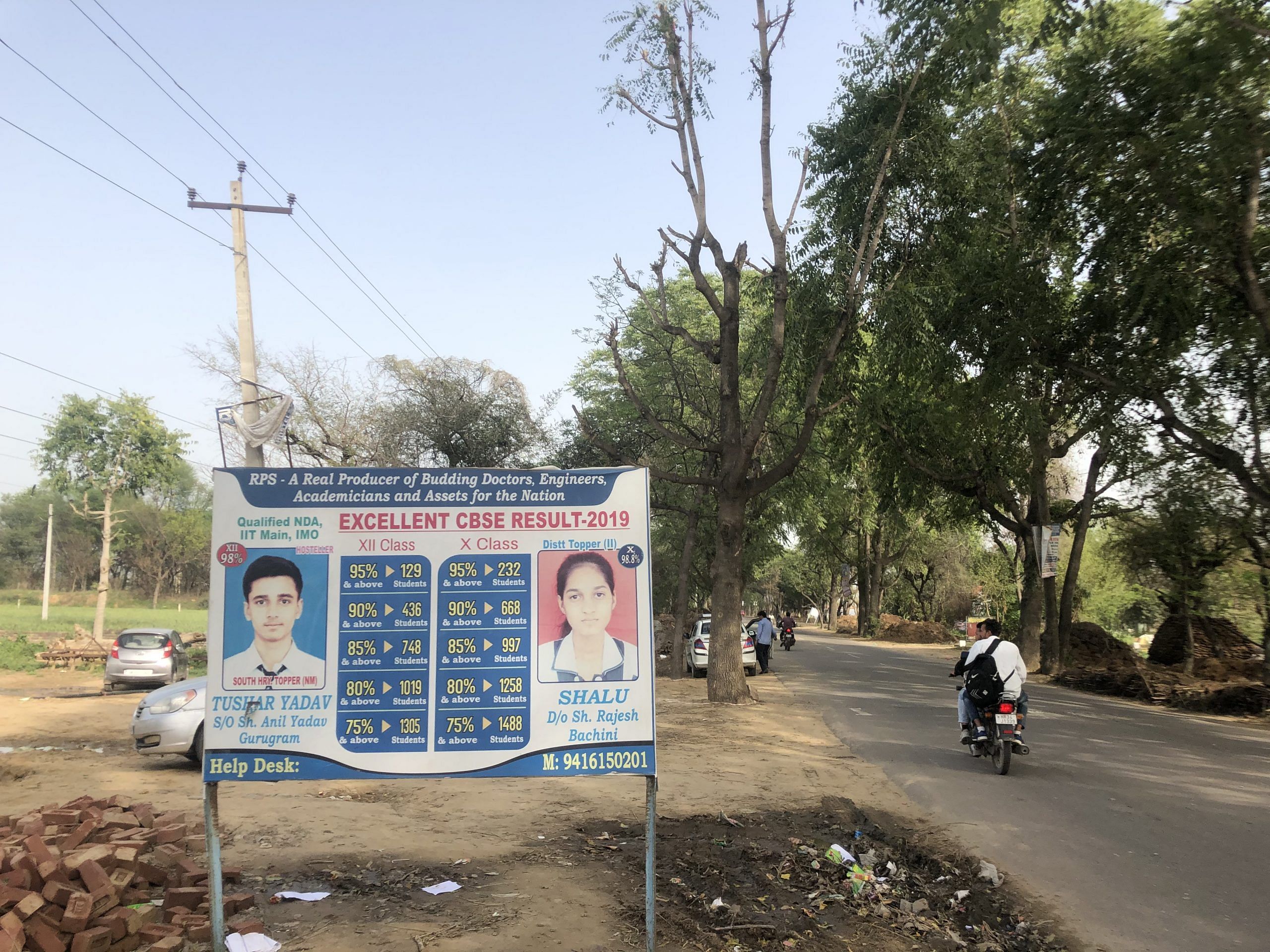 Hoardings advertise the toppers of each schooling's Mahendragarh | Photo: Jyotiraditya Yadav | ThePrint