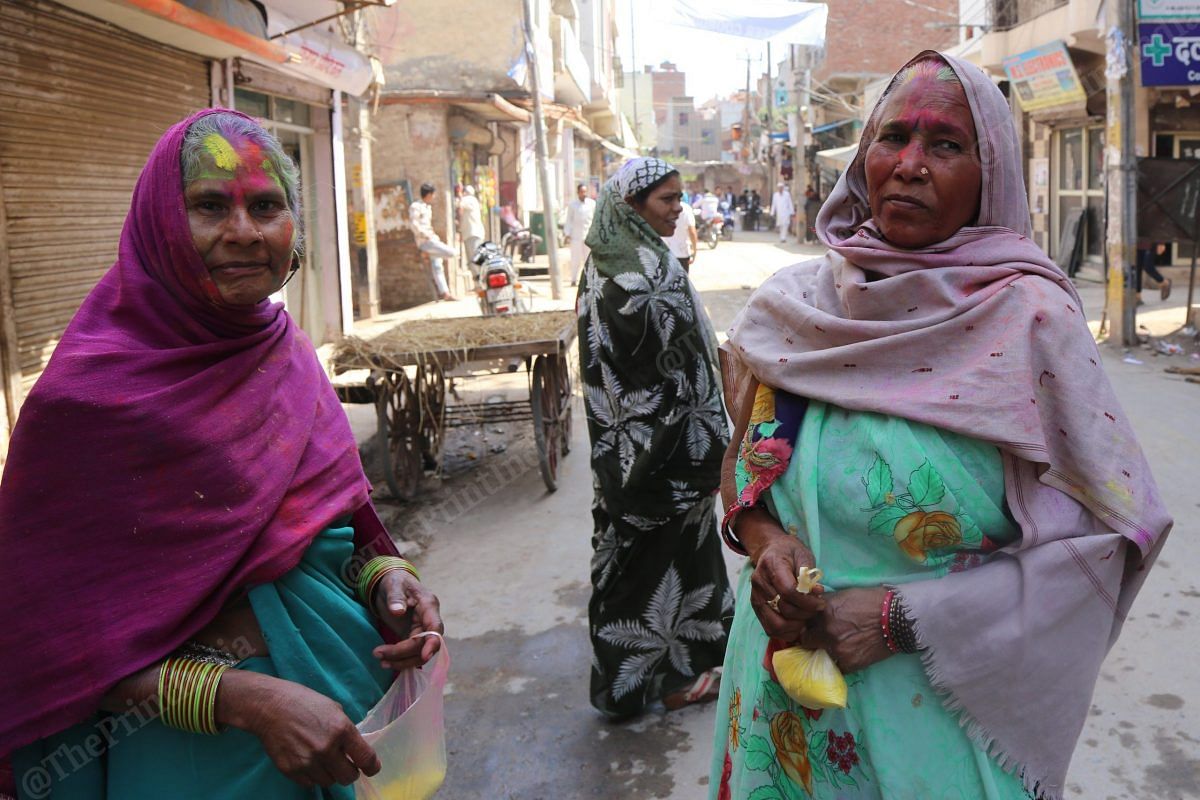 Women in Mustafabad area come out of their homes with colours in hand | Photo: Manisha Mondal | ThePrint