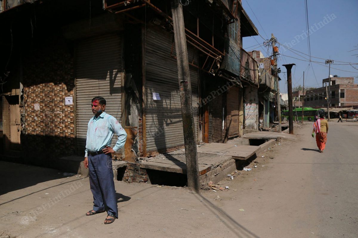 Ganga Singh standing at the empty Shiv Vihar street | Photo: Manisha Mondal | ThePrint