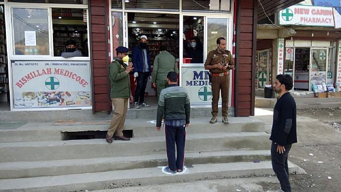 People stand at one meter distance in a queue while waiting to shop at a medical store, in Srinagar on Monday | ANI