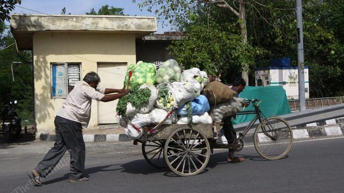 Vegetable suppliers pushing a cart during the coronavirus lockdown in Delhi Wednesday | Photo: Praveen Jain | ThePrint