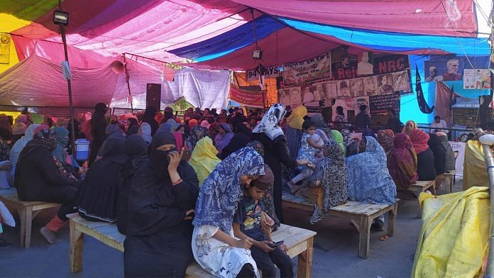 Women sit on wooden benches at the Shaheen Bagh protest site | Photo by special arrangement