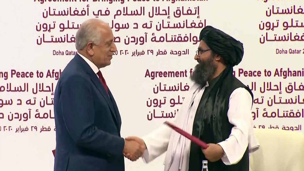 United States Special Representative for Afghanistan Zalmay Khalilzad and top Taliban leader Mullah Abdul Ghani Baradar shake hands after signing the peace agreement, in Doha on 29 February