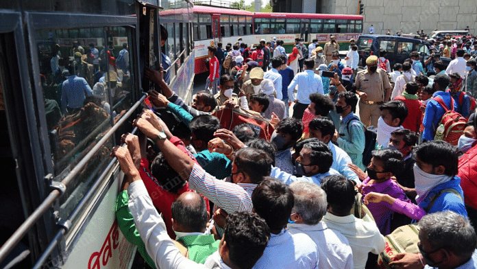 File photo | A crowd of migrant workers gather around the UPSRTC buses near the Delhi-Ghaziabad border | Photo: Suraj Singh Bisht | ThePrint