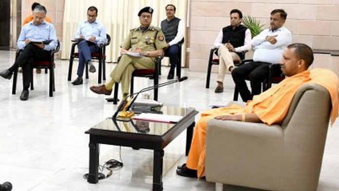 Uttar Pradesh Chief Minister Yogi Adityanath with police and administration officials at his residence Tuesday (representational image) | Photo: UP Information & Public Relations Department