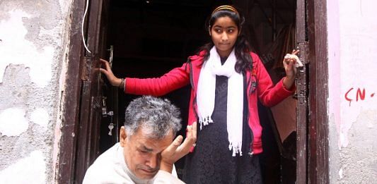 Asif Saikiya with his 14-year-old daughter Alvina, return to their ransacked home in Shiv Vihar. | Photo: Praveen Jain | ThePrint