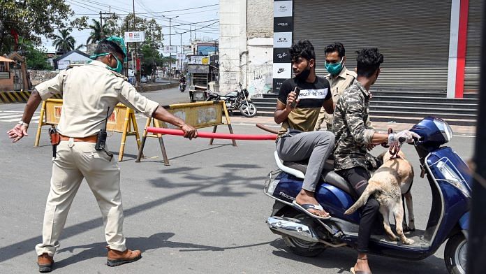 Police personnel stop commuters for venturing out of their homes, during a nationwide lockdown, imposed in the wake of coronavirus pandemic | PTI