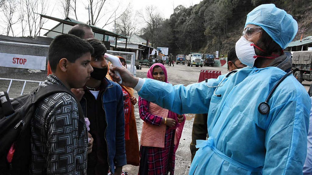A medical worker checks the body temperature of a man while screening people for Covid-19 in Jammu and Kashmir | Representational image | Photo: ANI