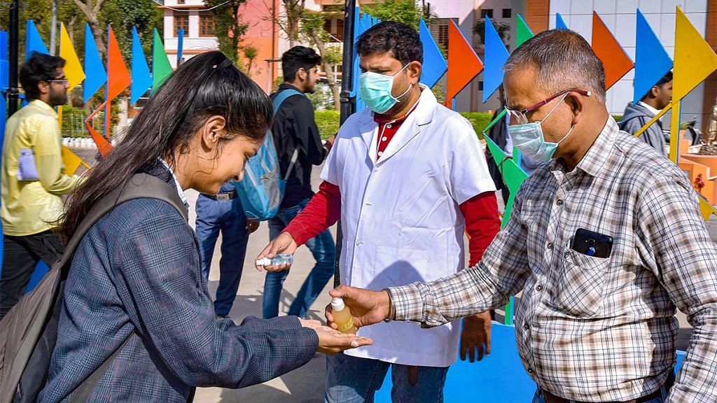 Students sanitise their hands outside a school in Bikaner | PTI