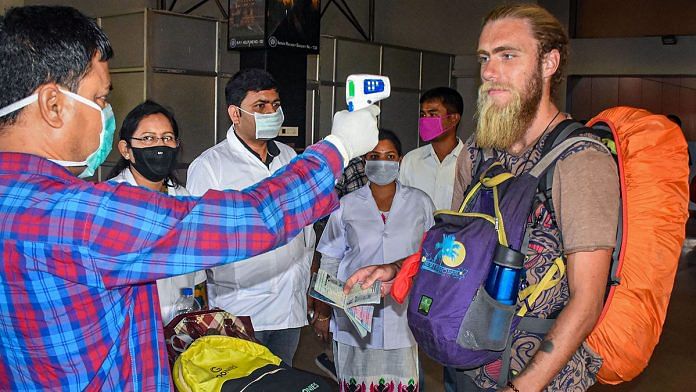 Thermal screening of passengers at Guwahati Railway Station | PTI