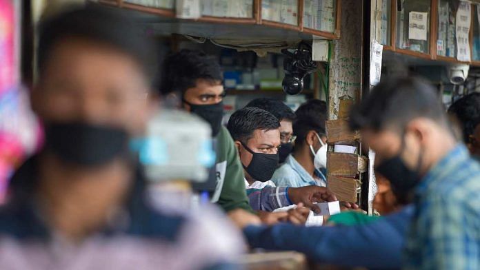 Salesmen at a chemist shop wear protective masks in wake of new cases of novel coronavirus being reported in India | PTI