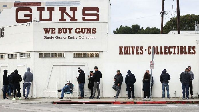 People stand in line outside the Martin B. Retting, Inc. guns store on March 15, 2020 in Culver City, California. The spread of Coronavirus (COVID-19) has prompted some Americans to line up for supplies in a variety of stores. | Photo by Mario Tama/Getty Images | Bloomberg