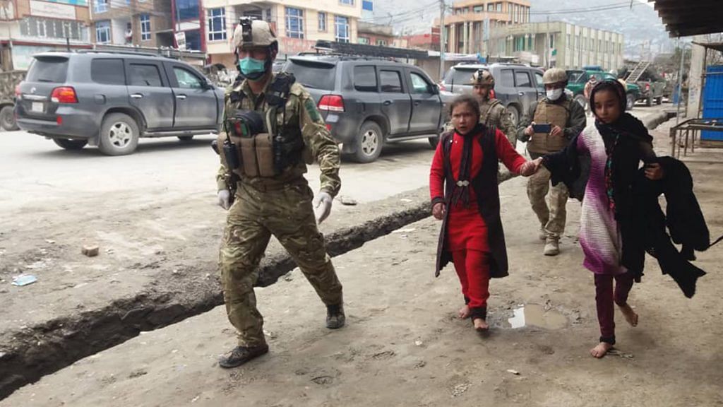 Security personnel escorting those trapped inside the gurdwara attacked by IS gunmen in Kabul, Afghanistan | Twitter | @TOLOnews