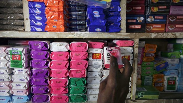 A man takes a bar of Hindustan Unilever Ltd. Lux soap off a shelf at a store in Mumbai, India. (Representational Image) | Photographer: Kuni Takahashi | Bloomberg