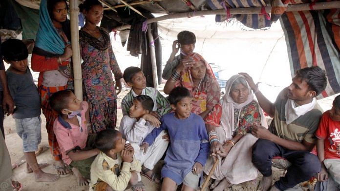 Bachana Devi with her children and grandchildren. The family lives in a tiny jhuggi in Indrapuri, Ghaziabad | Praveen Jain | ThePrint