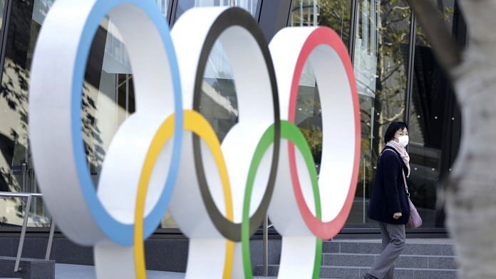 A pedestrian walks past the Olympic rings outside the Japan Olympic Museum near the New National Stadium, the main venue for the Tokyo 2020 Olympic and Paralympic Games, in Tokyo | Photo: Kiyoshi Ota | Bloomberg