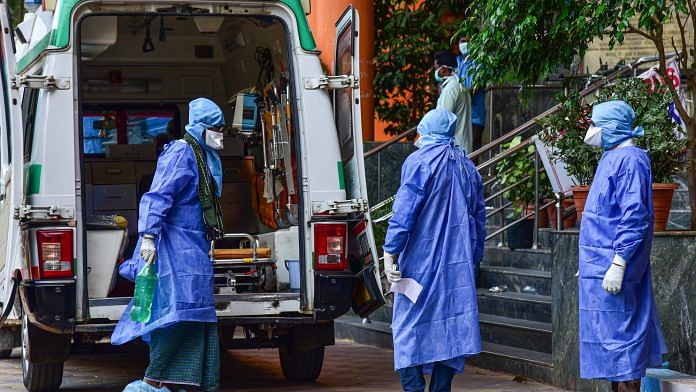 Medical workers attend to a suspected coronavirus patient as he is shifted to the isolation ward of Gandhi Hospital, in Hyderabad