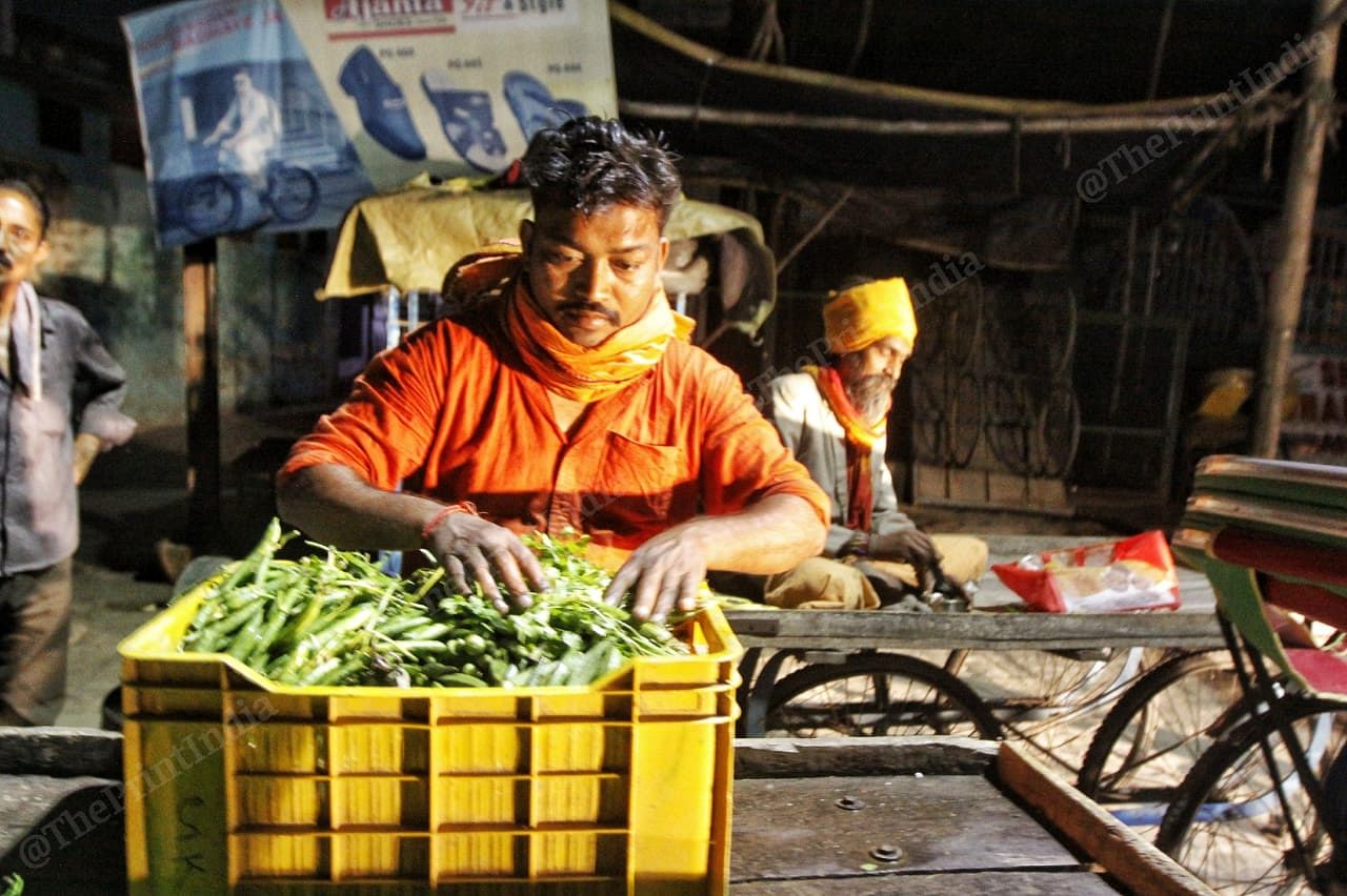 Rajesh Sonkar, a vegetable seller and Ram Prasad (behind him) working with a band company | Photo: Praveen Jain | ThePrint