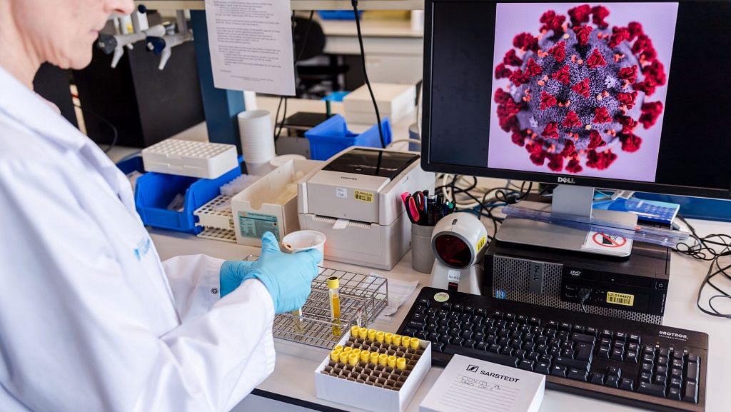 A magnified coronavirus germ is displayed on a desktop computer monitor during coronavirus patient sample detection tests in the virology research labs (Representational Image) | Photographer: Geert Vanden Wijngaert | Bloomberg