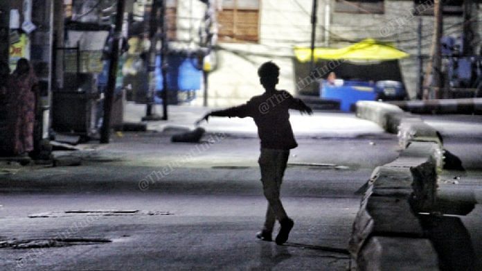 Child playing during night on the streets | Photo: Praveen Jain | ThePrint