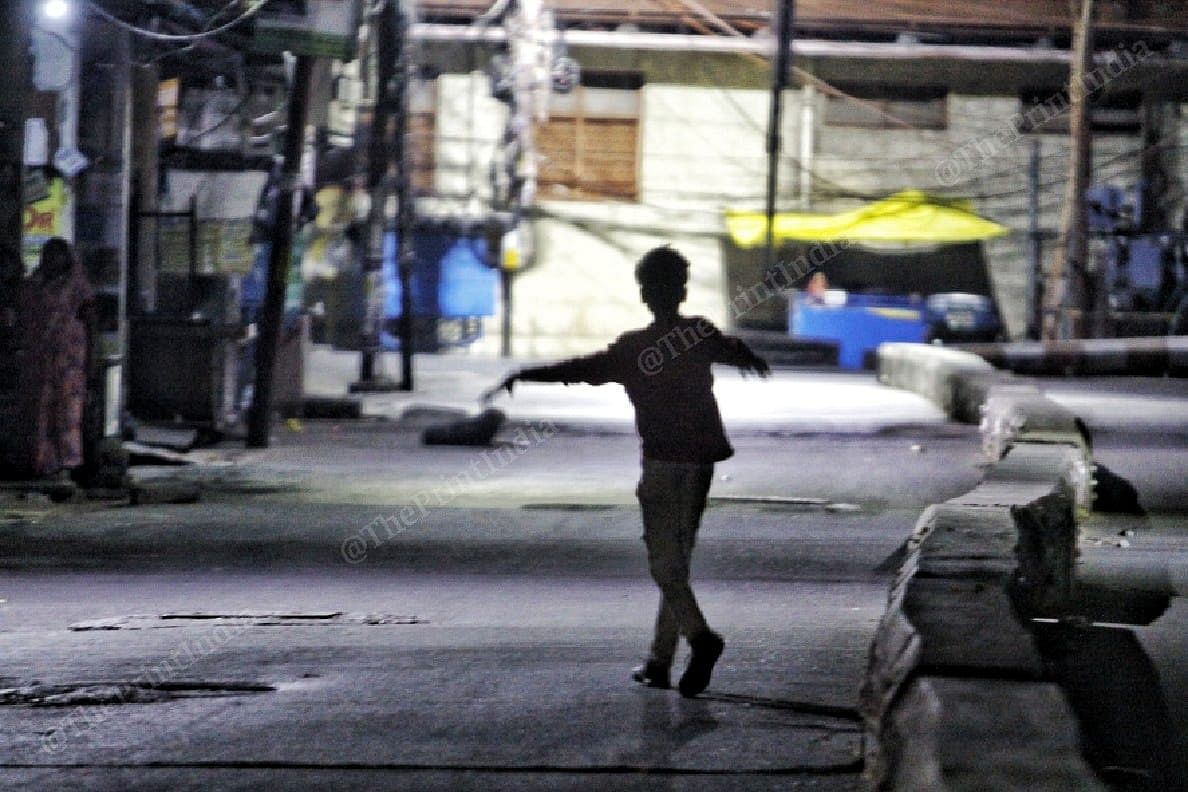 Child playing during night on the streets | Photo: Praveen Jain | ThePrint