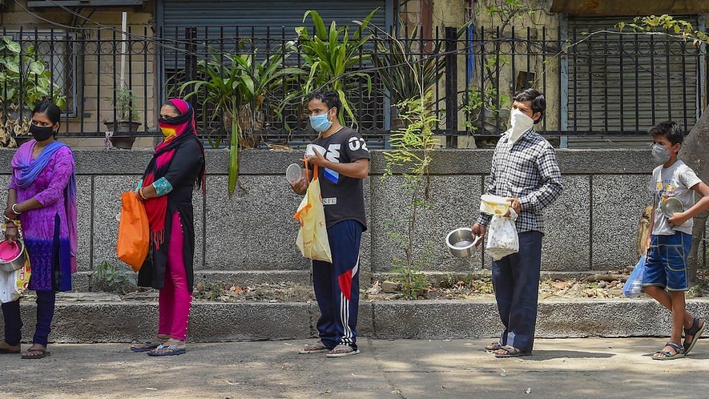 Representational image | People stand in a queue to collect free food distributed by volunteers during coronavirus lockdown, in Shahpur Jat area of New Delhi | PTI