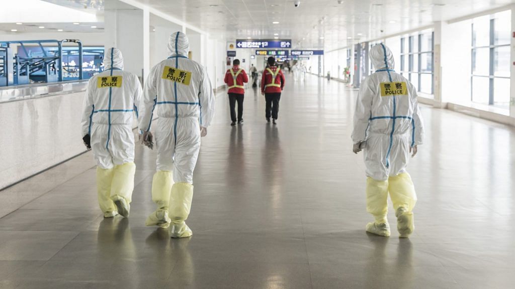 Representational image. Airport employees wear full body protective suits at Pudong International Airport in Shanghai on 28 March. | Photographer: Qilai Shen | Bloomberg