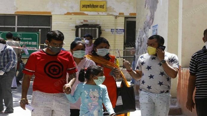 A family wearing masks outside Agra district hospital (representational image) | Photo: Praveen Jain | ThePrint