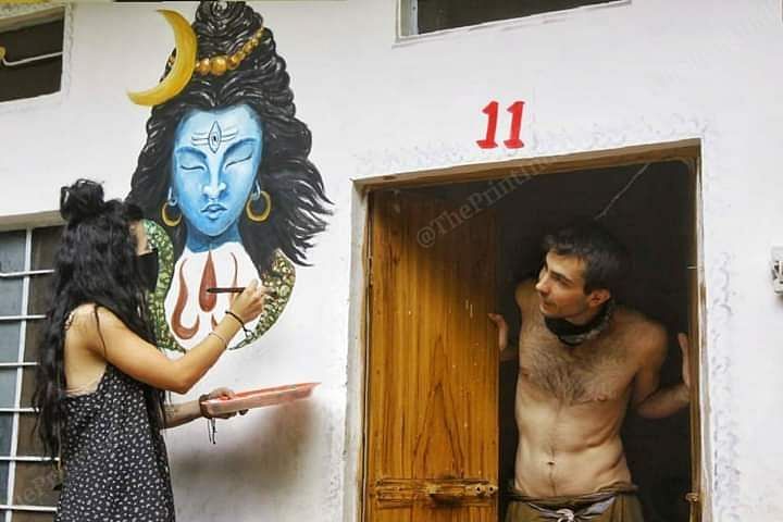 A tourist from Italy paints an image of Shiva to pass the time at her hotel in Pushkar. Photo: Praveen Jain | ThePrint