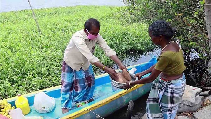 A Kerala boatman brings essential items to island residents in Alappuzha