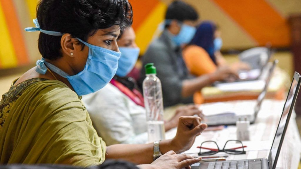 Employees of Health Tele Helpline center work during a nationwide lockdown in the wake of coronavirus pandemic, at IMA house Ernakulam District in Kochi on 18 April, 2020 | PTI