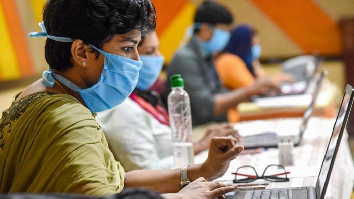 Employees of Health Tele Helpline center work during a nationwide lockdown in the wake of coronavirus pandemic, at IMA house Ernakulam District in Kochi on 18 April, 2020 | PTI