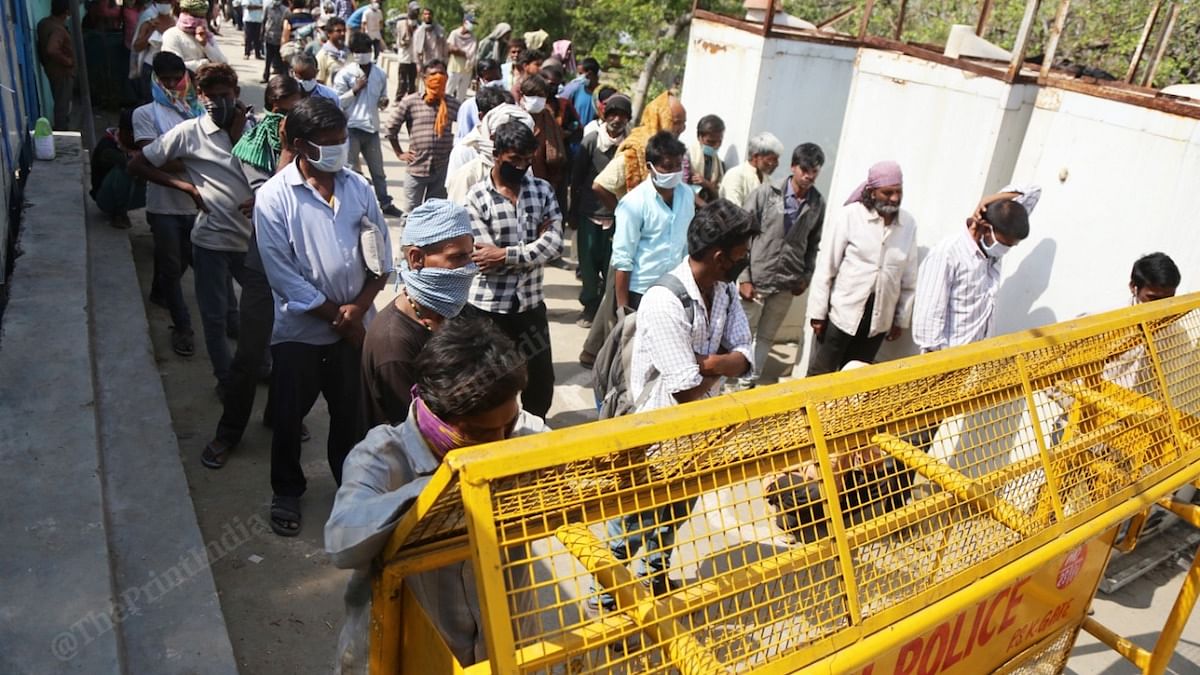 Homeless people and migrant workers stand in queue for food at a shelter home in Delhi | Manisha Mondal| ThePrint
