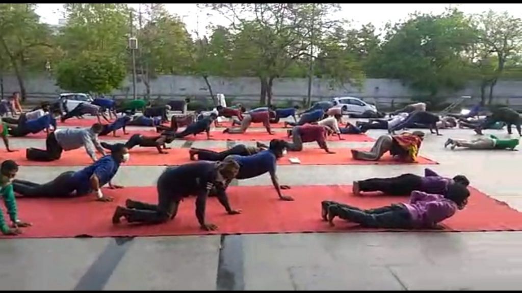 Migrant workers during a PT session at Yamuna Sports Complex in New Delhi