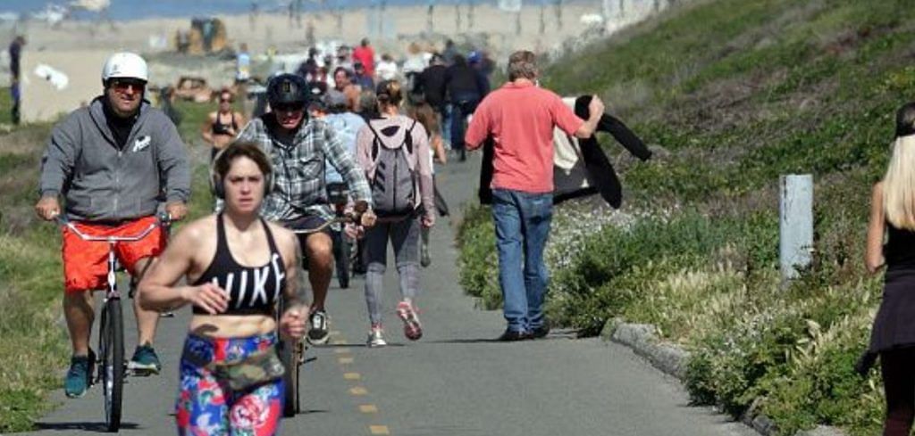 People exercise along a bike path on March 28, 2020 in Huntington Beach, California. Photo | Bloomberg