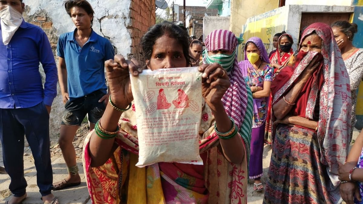 A resident shows a packet of sattu, which they've been forced to eat in the absence of rice and wheat
