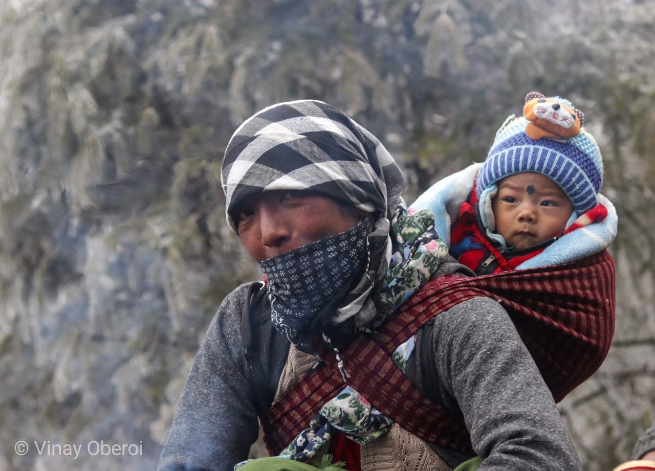 A road maintenance worker keeps the Sela pass open and the baby warm | Vinay Sheel Oberoi