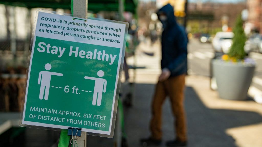 A sign instructs people to stay six feet away at a farmers' market in the Bronx borough of New York, U.S. | Photo: David Dee Delgado | Bloomberg