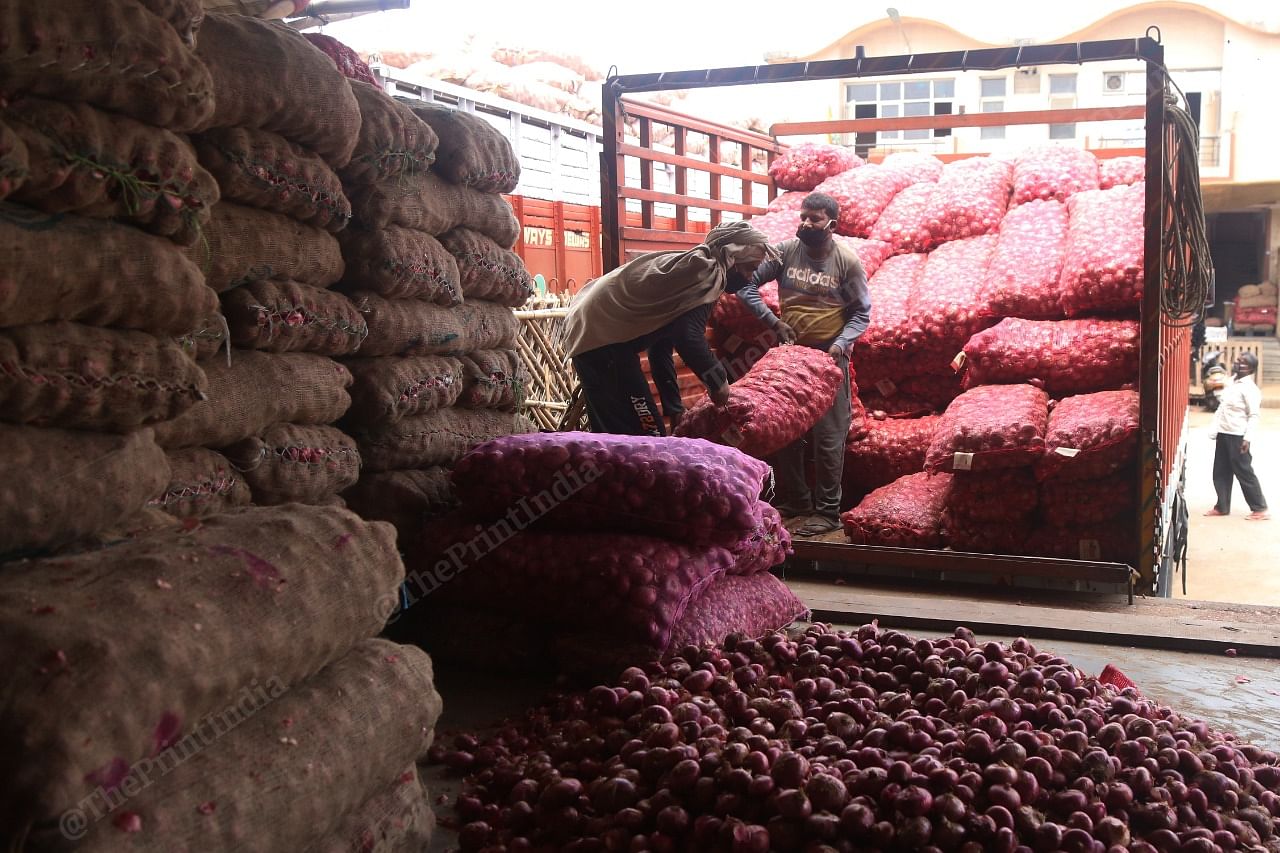 Labourers unloading sacks of onion in Azadpur mandi in Delhi | Photo: Manisha Mondal | ThePrint