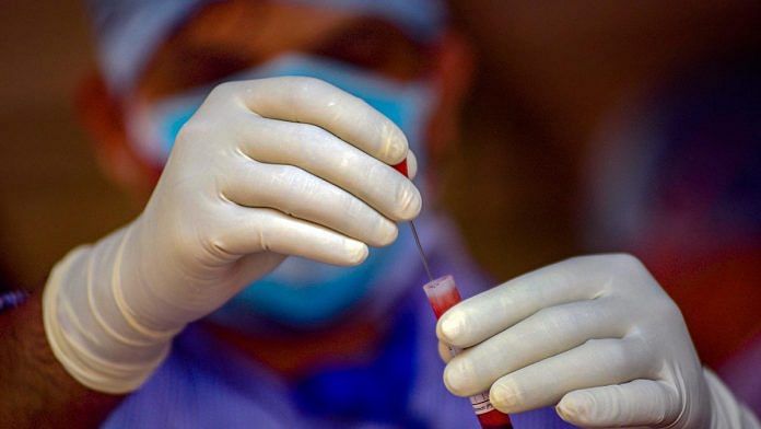 A medic works with a sample for a rapid antibody test in Bhubaneshwar, Odisha | Representational image | PTI