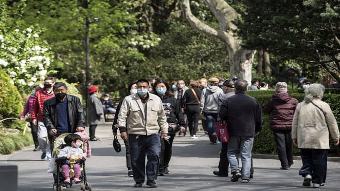 People wearing masks in a park in Shanghai, China | Qilai Shen | Bloomberg