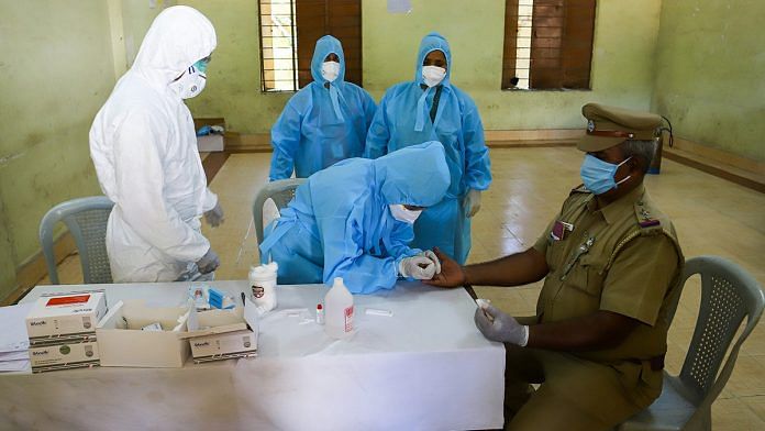 A police officer gives a sample for a rapid test of Covid-19 in Chennai | PTI