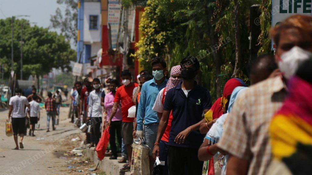 People standing in queue to buy groceries during coronavirus lockdown in Delhi's Bhajanpura | Photo: Manisha Mondal | ThePrint