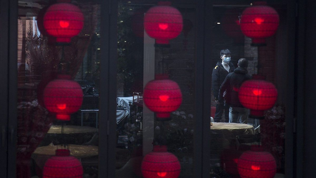 Daliy Life In Wuhan As Coronavirus Cases Under Control A waiter is standing outside the restaurant in a shopping district on April 01, 2020 in Wuhan, Hubei, China.(Representational Image) | Photo by Getty Images | Bloomberg