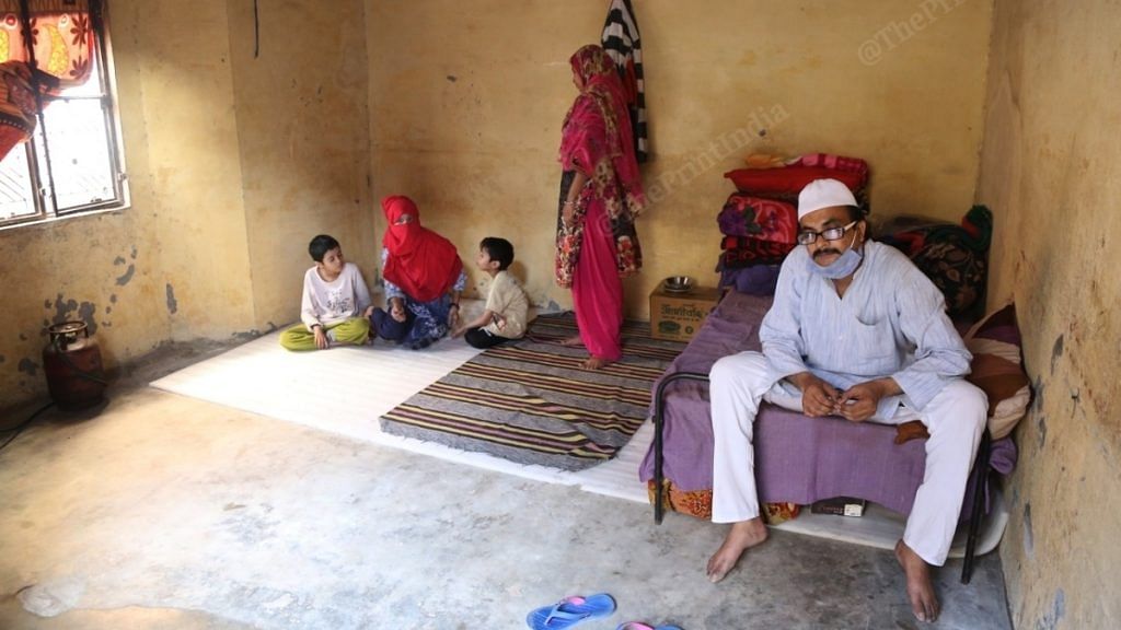 Sageer Ahmed and wife Reshma Ahmed with their children in a small room in Delhi's Mustafabad. The landlord is not charging any rent | Photo: Manisha Mondal/ThePrint