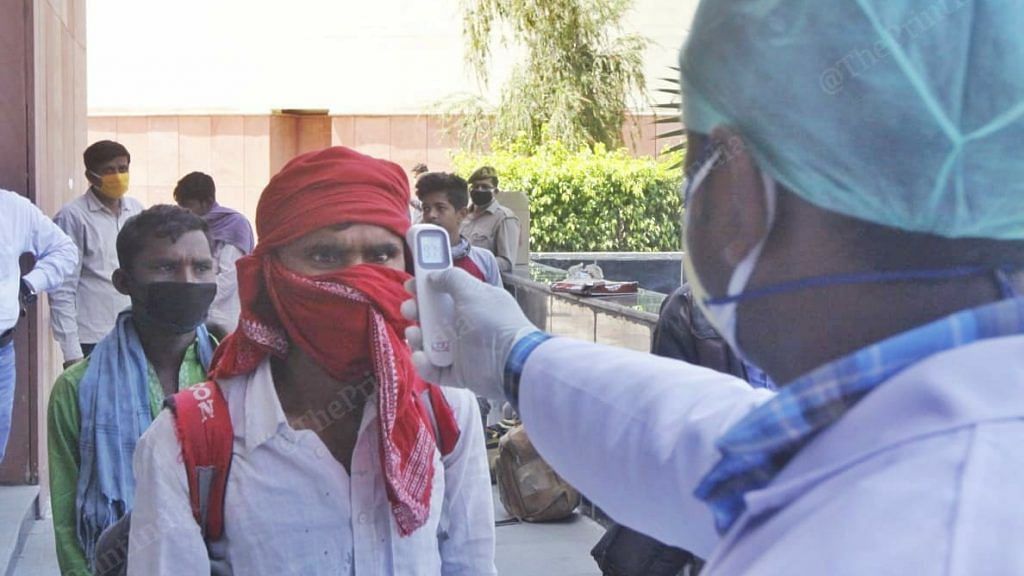 A doctor checks the temperature of a migrant worker as part of the screening process. (representational image) | Photo: Praveen Jain | ThePrint