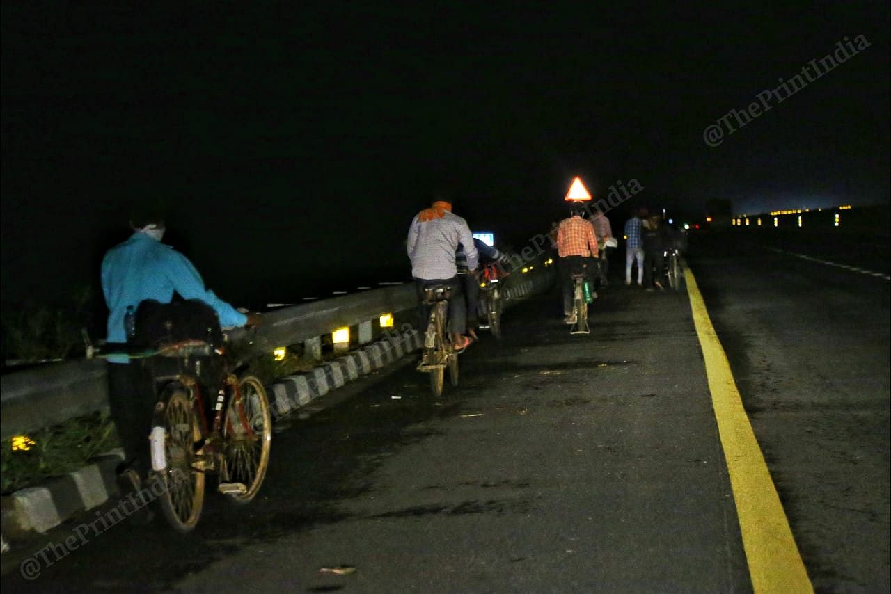 A group of men with their bicycles on the way to Uttar Pradesh in the dead of the night. | Photo: Suraj Singh Bisht/ThePrint
