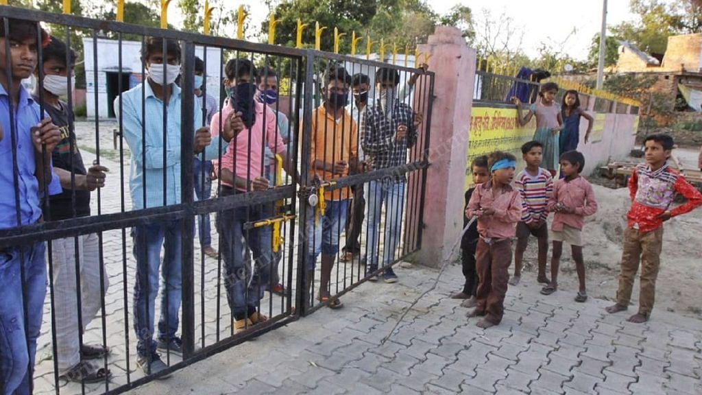 Children at the main gate of village school that has been converted into an isolation centre | Photo: Praveen Jain | ThePrint